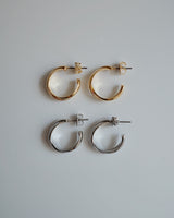 shiny cross hoop pierce